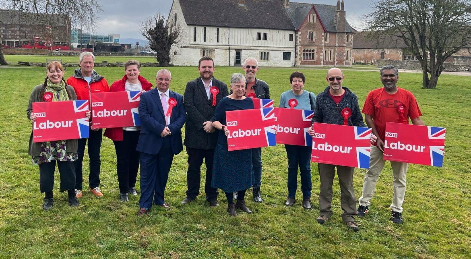 Gloucester Labour County Council candidates standing outside holding Vote Labour placards. They are joined by Alex McIntyre MP.